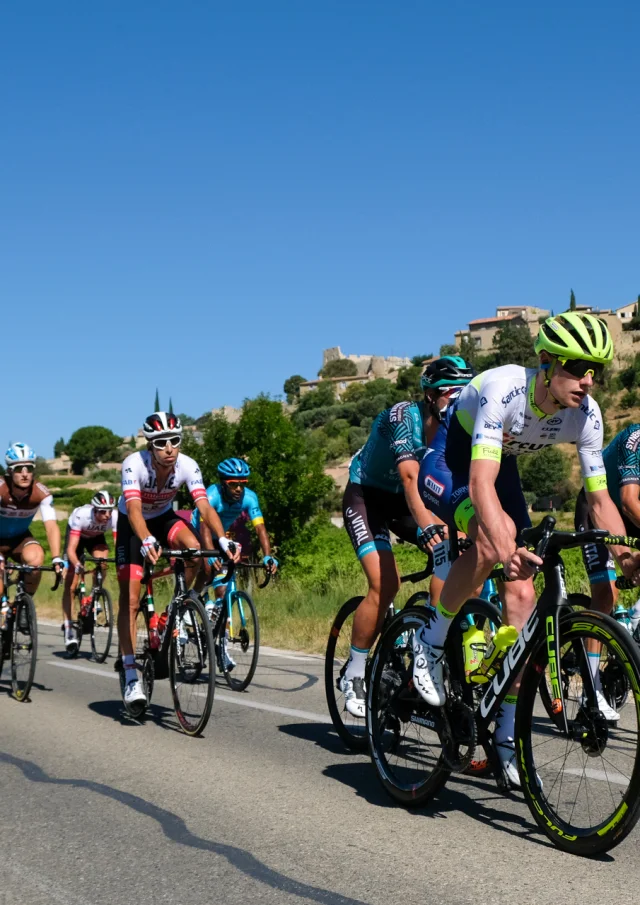 Cyclists pass the village of Faucon during the 2020 Mont Ventoux denivelé challenges.